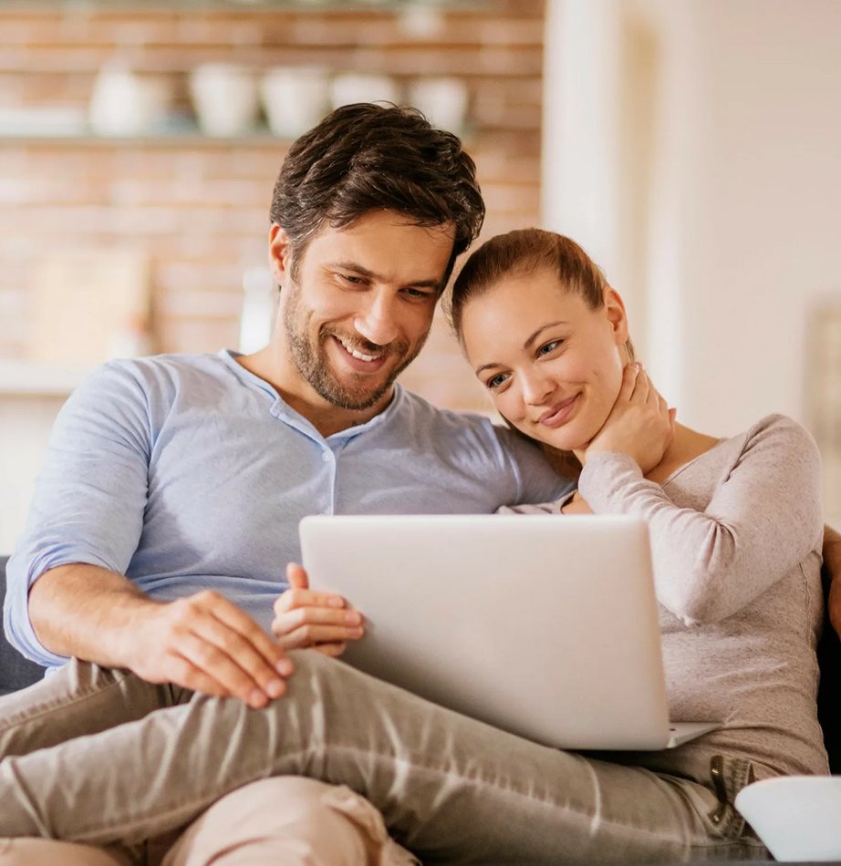 Happy couple using a laptop
